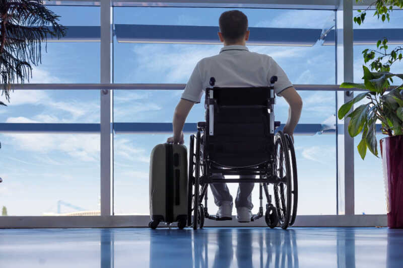 Man in the wheelchair waiting for his plane to arrive